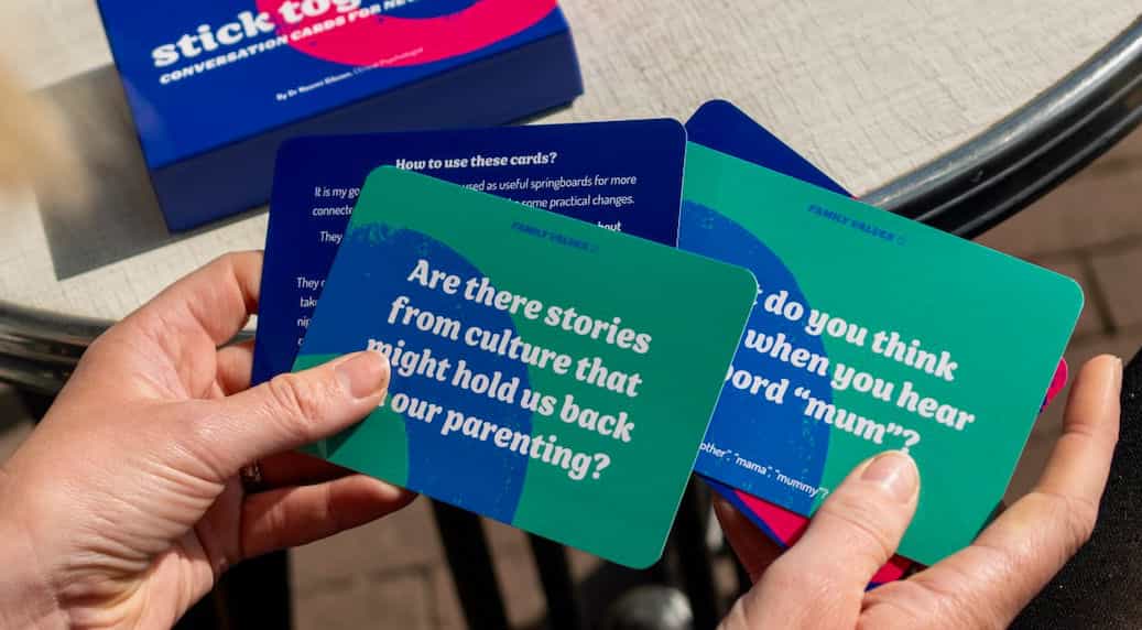 Photo of hands holding a few of the conversation cards